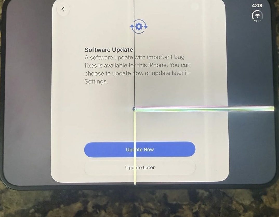 Wyświetlacz smartfona z informacją o aktualizacji oprogramowania i przyciskami „Update Now” oraz „Update Later”, ekran z kolorowymi pasami